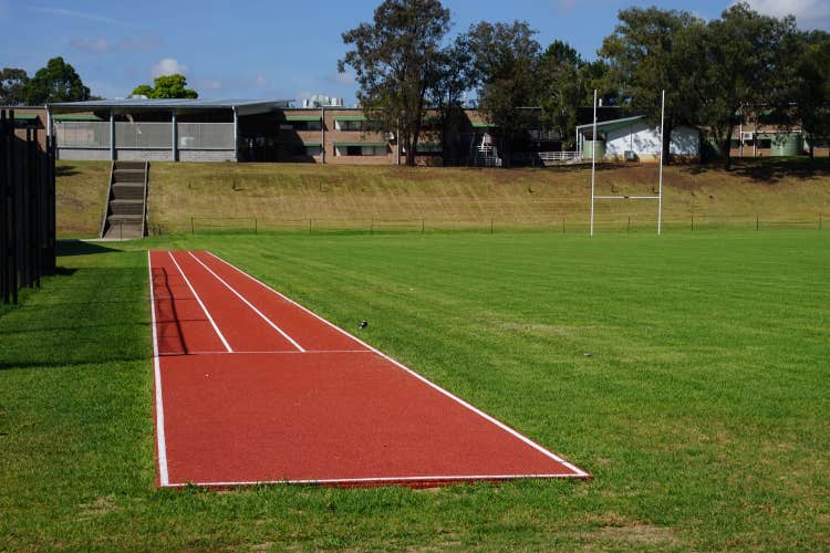 A three lane running track with red synthetic surfacing.