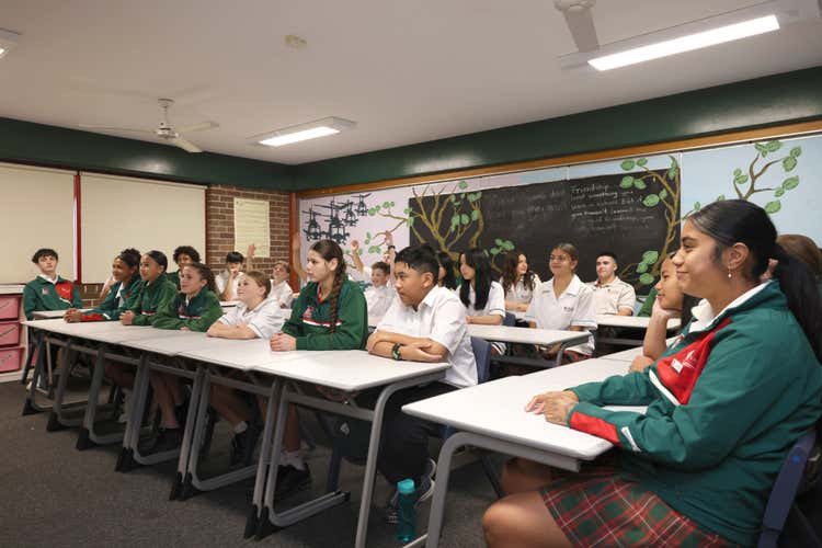 Students sitting at tables in a classroom