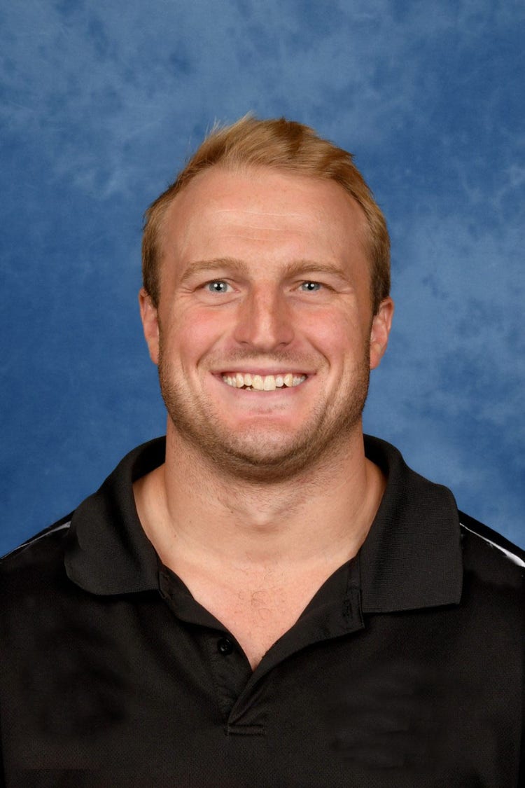 A picture of rugby league coach Alec Bush wearing a black polo shirt.